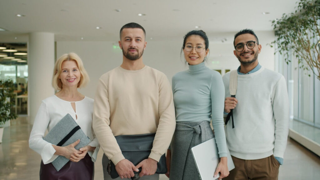 Diverse group of professionals standing together indoors.