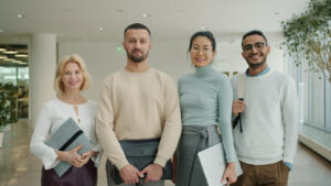Diverse group of professionals standing together indoors.