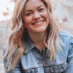 woman smiling wearing denim jacket